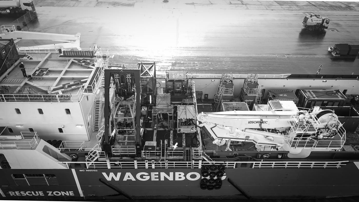Aerial view of the MSV Kingsborg working deck alongside, loaded with subsea containers and a deck crane